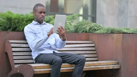 African Man having Loss on Tablet Outdoor Video stock 136032476