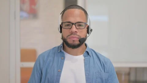 African Man with Headset Looking at Camera in Call Center Stock Footage 256034929