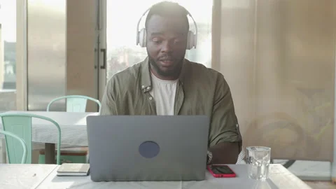 African man with helmets making a video call and jotting down ideas. Video stock 162332646