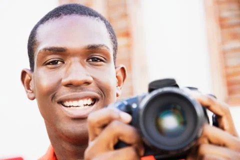 African man holding digital camera Stock Photos