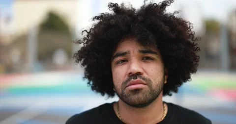 African man looking at camera inside basketball court Stock Footage 183005693