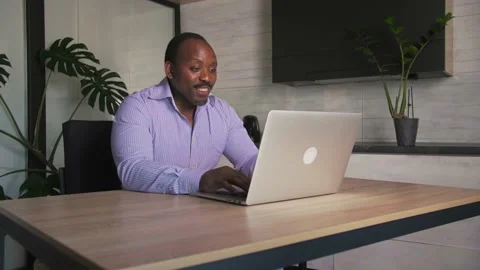 African man makes a video call with his parents using a laptop on the table Stock Footage 201292201