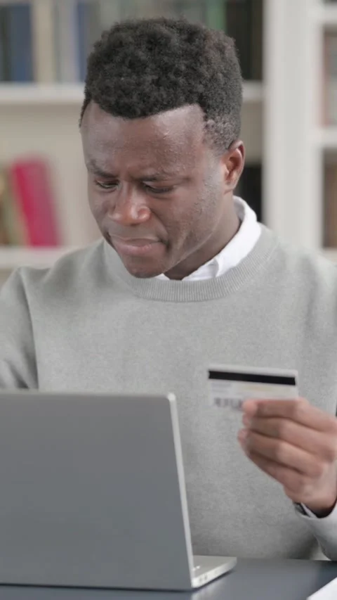 African Man making Online Payment Failure on Laptop in Library, Vertical Video Stock Footage 339576248