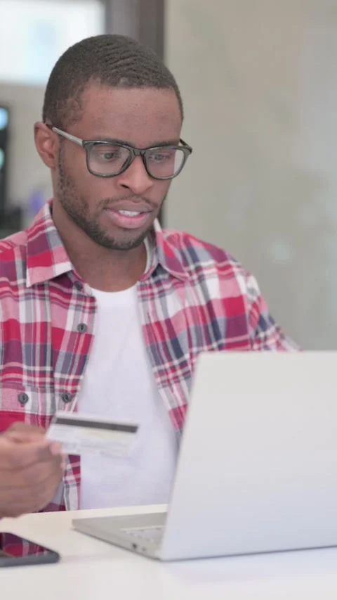 African Man making Online Payment Failure on Laptop, Vertical Video Stock Footage 340040152