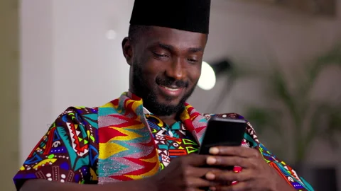 African Man Making Payment at home with smartphone. Video stock 345827980