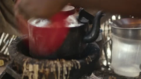 African Man making traditional tea on traditional fire 2 스톡 동영상 345099347