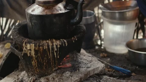 African Man making traditional tea on traditional fire Stock Footage 345099378