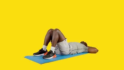 African man on a mat doing roll up exercise Stock Footage 242911938