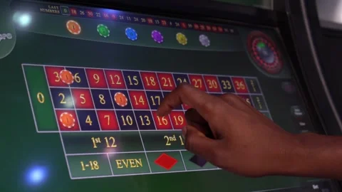 African man playing a game of roulette on a slot machine Stock Footage 256793989