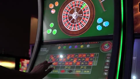 African man playing a game of roulette on a slot machine Stock Footage 256794149