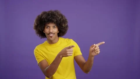 African man pointing surprised to the side 스톡 동영상 234857336