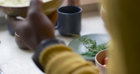 African man reaching and placing chive mashed potatoes on counter to serve, Stock Footage 337289581