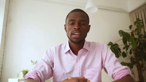 African man recording video message, talking on webcam at interview Stock Footage