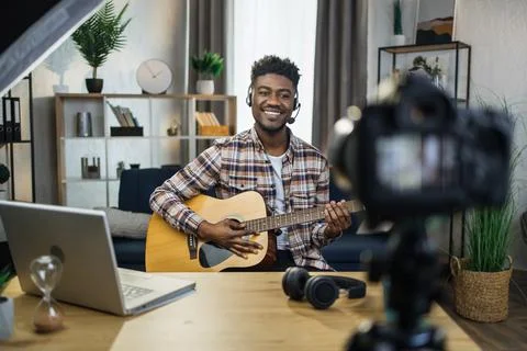 African man recording video tutorial how to play guitar Fotos Stock