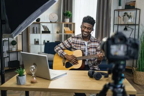 African man recording video tutorial how to play guitar 스톡 사진