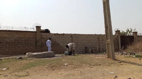 African Man Relieving Himself By Roadside Well Hadejia Road Kano Nigeria 動画素材 328221855
