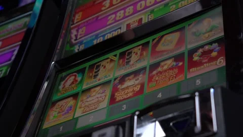 African man selecting a slot machine game at a casino Stock Footage 256791560
