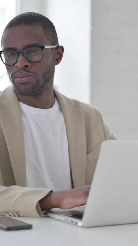 African Man Shaking Head as No Sign while using Laptop in Office, Vertical Video Vídeo Stock 337350072