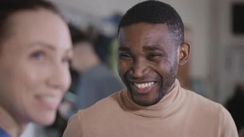 An African man in a shop or at work, discussing a project and news with a female Stock Footage 229172053
