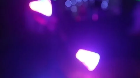 African man shows a performance with fluorescent lights in a nightclub, blurred Stock Footage 86269880
