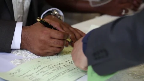 African man signing wedding register Stock Footage