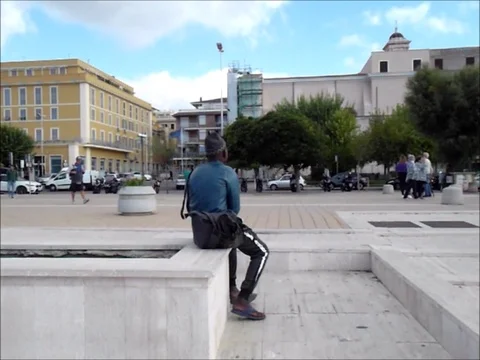 African man sitting on the wall Stock Footage 118128457