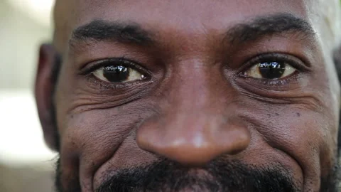 African man smiling at camera. close-up macro eyes staring grinning Stock Footage 155346457