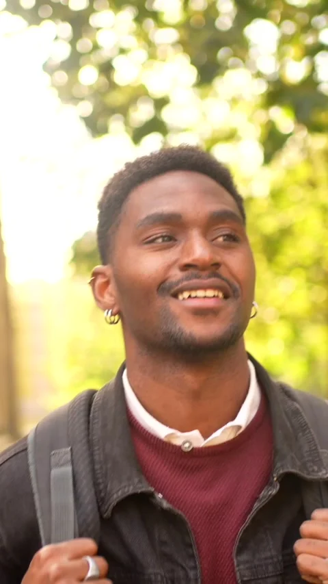 African man smiling while exploring a city Stock Footage 295267298