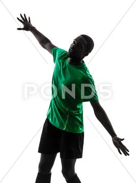 African man soccer player scoring silhouette Stock Photos
