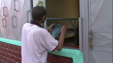 African man standing at backery shop buying bread Stock Footage