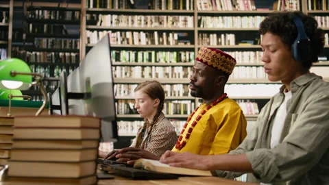 African man student working at desktop computer and wearing traditional clothes Stock Footage 337228787