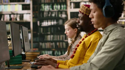 African man student working at desktop computer and wearing traditional clothes Stock Footage 337230561