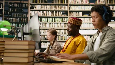 African man student working at desktop computer and wearing traditional clothes Stock Photos