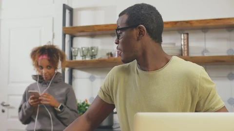 African man talking on phone in kitchen Stock Footage 106989983