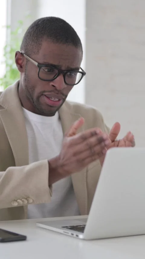 African Man Talking on Video Call on Laptop in Office, Vertical Video Stock Footage 337350021