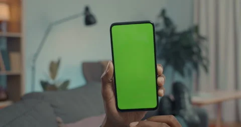 African man tapping on chroma key screen of smartphone Stock Footage 163830237