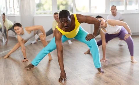 African man with team of like-minded multinational people learn to elements of Stock Photos