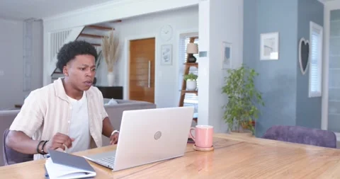 African man typing at table checking confusing laptop, standing and stretching, Stock Footage 337098465