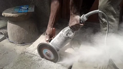 AFRICAN MAN USING CIRCULAR SAW Stock Footage 165184730