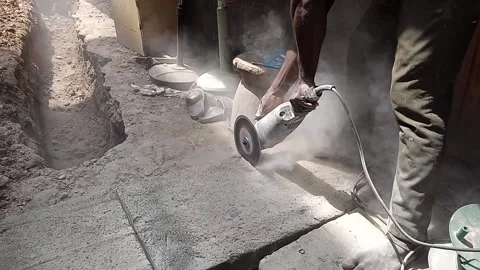 AFRICAN MAN USING A CIRCULAR SAW WITHOUT SAFETY EQUIPMENT Stock Footage 165184746
