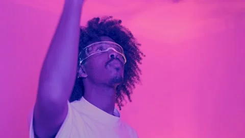 African man using an invisible touchscreen using artificial intelligence goggles Stock Footage 244068303