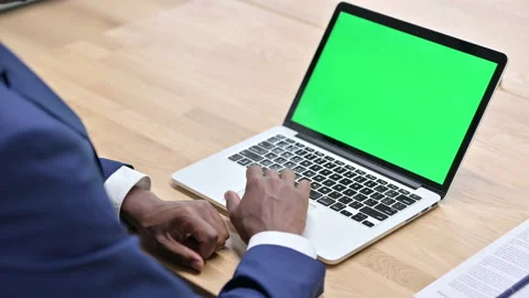 African Man Using Laptop with Chroma Screen Stock Footage 138488454
