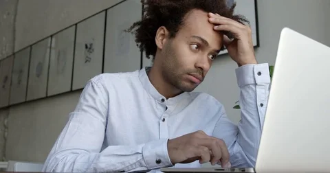 African man using laptop computer looking concentrated analyzing financial Stock Footage 82679367