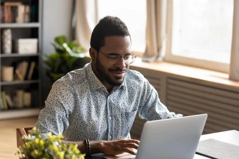 African man using notebook makes order e-commerce online services Stock Photos
