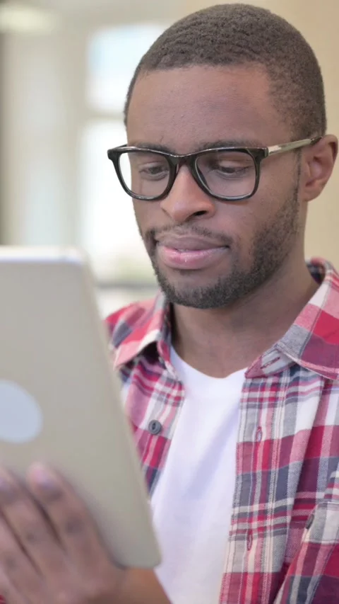 African Man using Tablet, Browsing Internet, Vertical Video Stock Footage 340041168