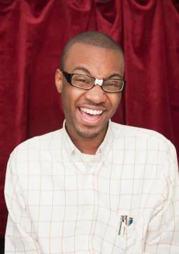 African man wearing taped eyeglasses and making a face Stock Photos