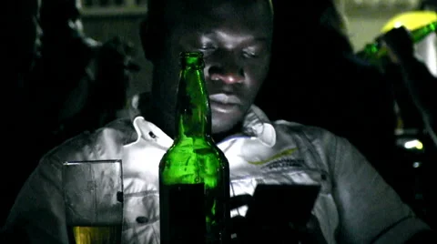 African man working with his mobile phone at night in a bar Stock Footage 47322155