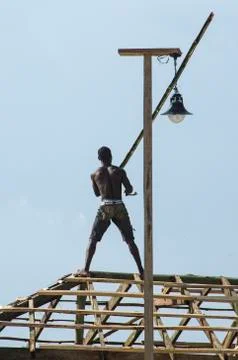 African Man Working on the Roof Stock Photos