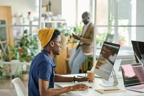 African man writing code on new software Stock Photos