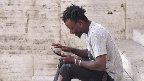 African man's hands using tablet pc outdoor. Side view Stock-Footage 218603401